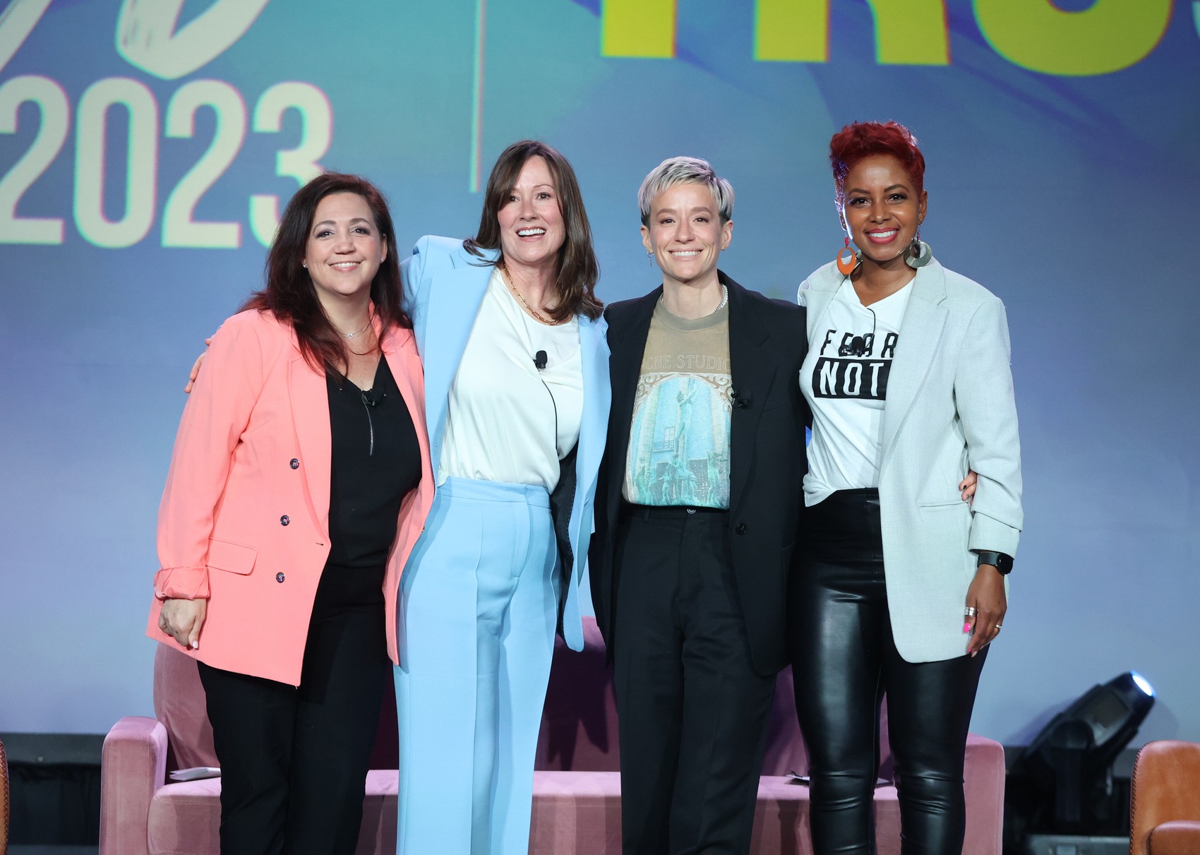 Tiana Sanchez on stage with fellow panelists at a 2023 conference