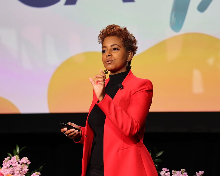 Tiana Sanchez delivering the Upside of Failure keynote on a main stage